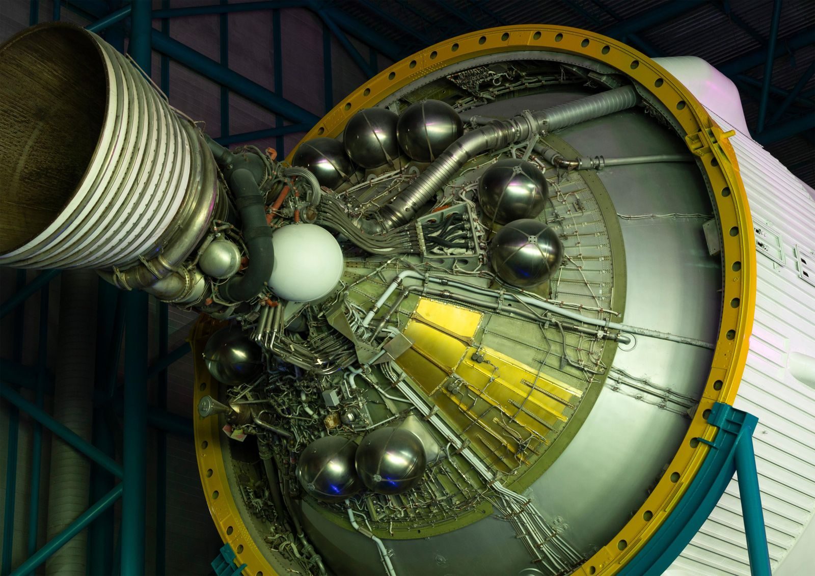 Intricate details of a large rocket engine showcasing its metal pipes and structures.