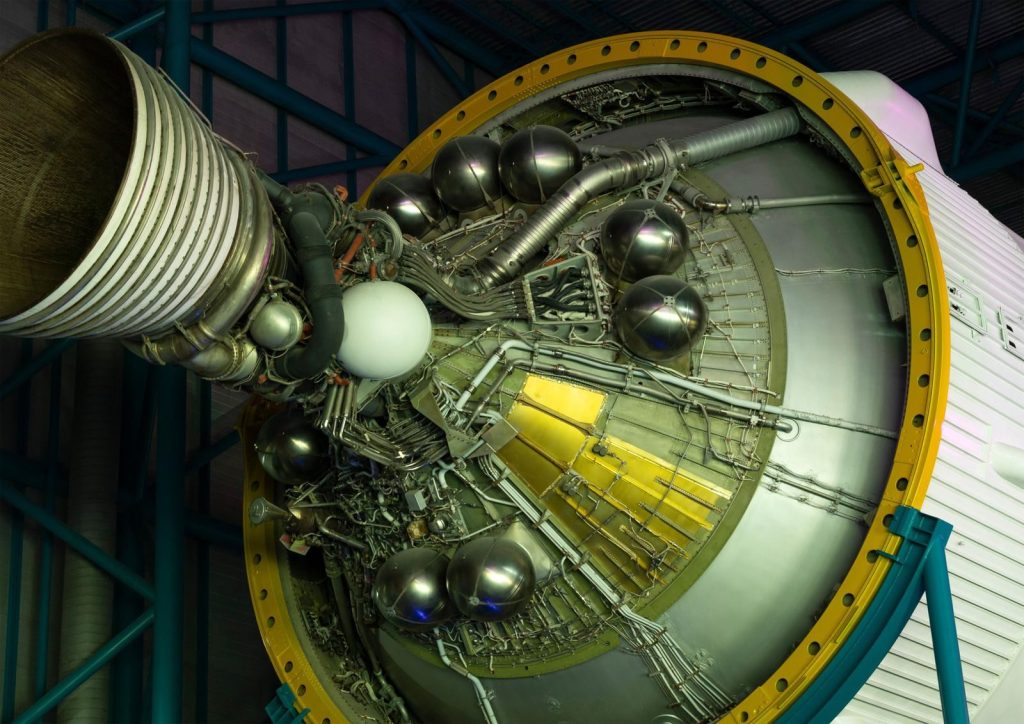 Intricate details of a large rocket engine showcasing its metal pipes and structures.