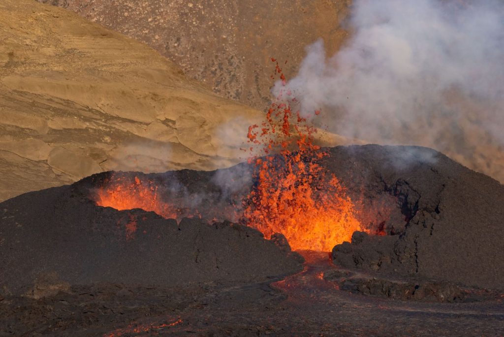 A powerful and radiant volcanic eruption with flowing lava and rising smoke, showcasing natural intensity.