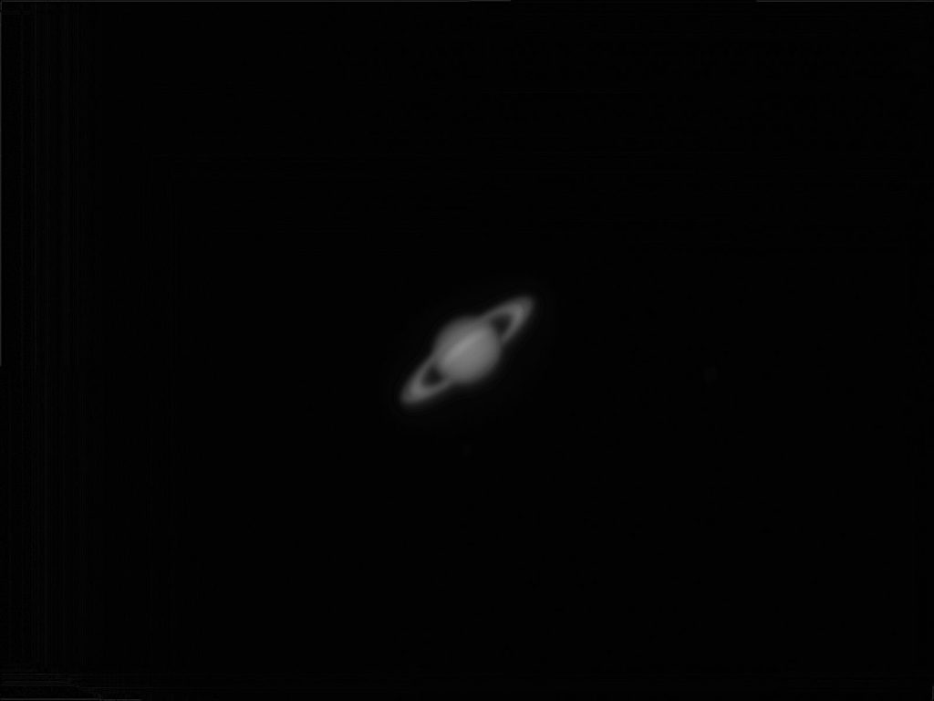 A captivating black and white photograph of Saturn showcasing its iconic rings.