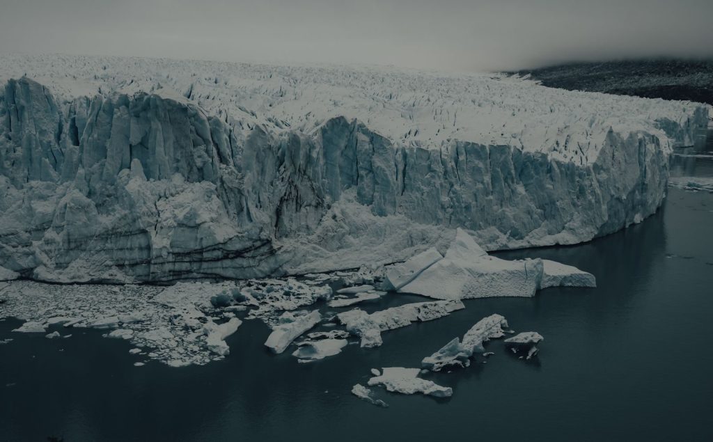 A stunning view of a massive iceberg amidst cold arctic waters, showcasing nature's grandeur.