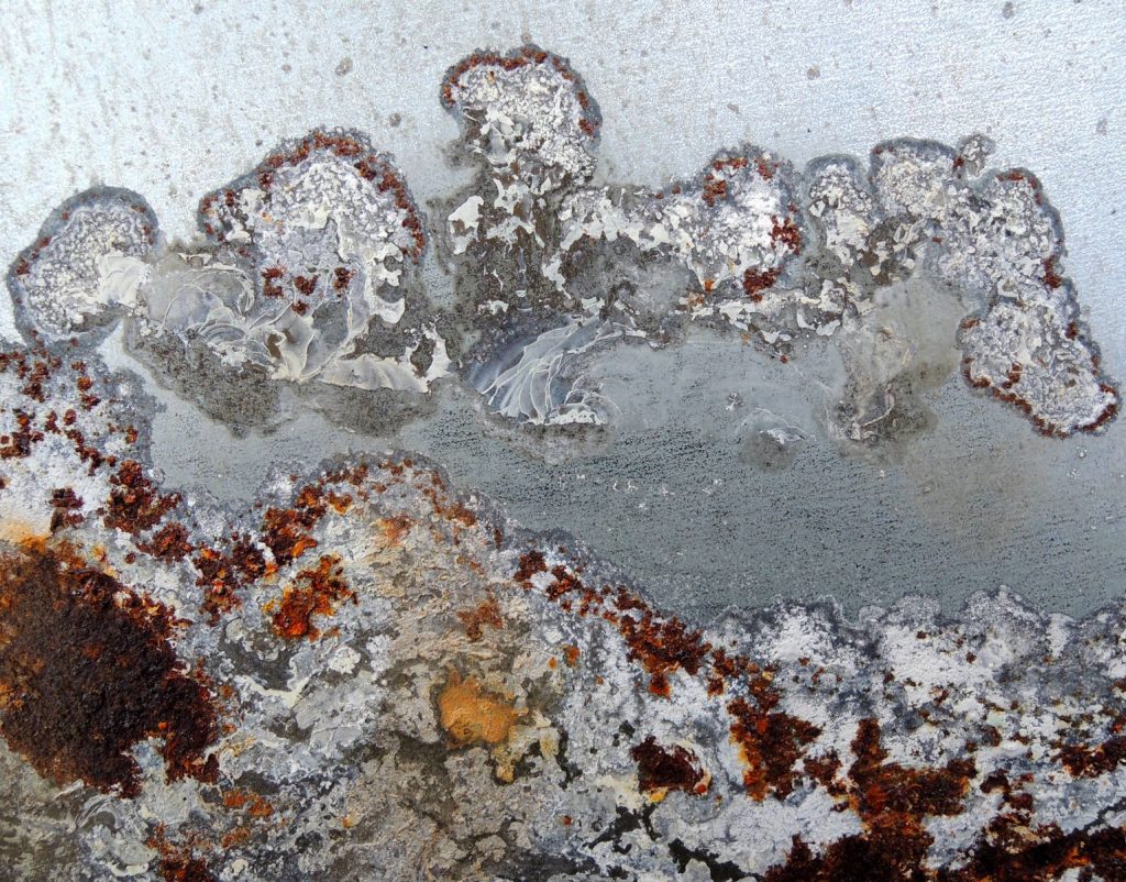 Detailed image showing corrosion and rust on an old metal surface, highlighting texture.