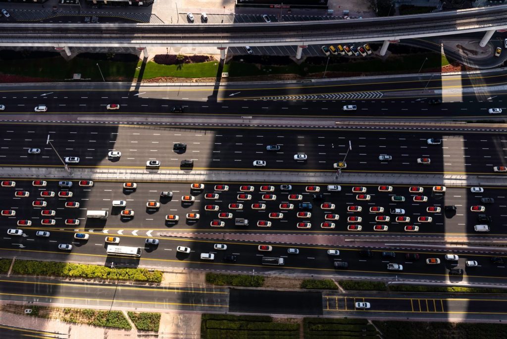 High angle view of busy traffic on Dubai highway, featuring cars and elevated roads.