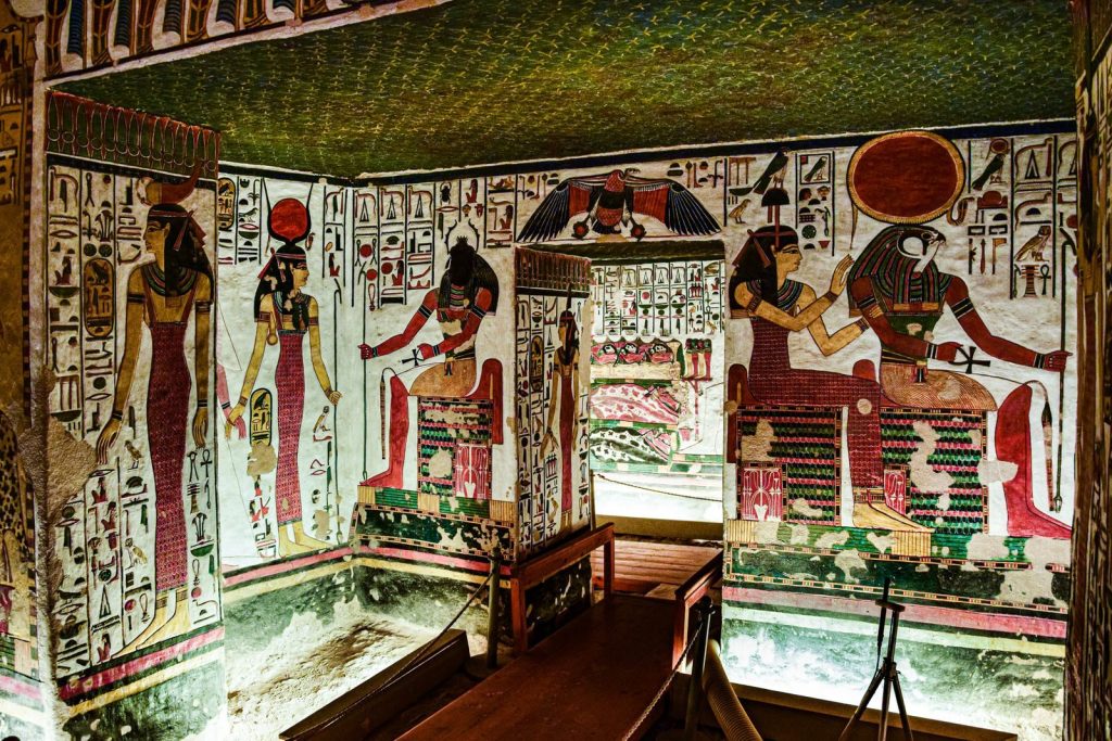 Colorful Egyptian murals depicting gods found inside an ancient tomb, rich in history.