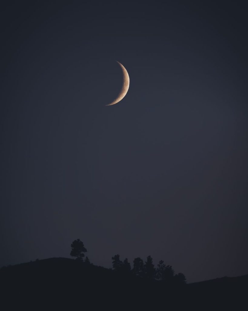 Captivating crescent moon illuminating the night sky over Wenatchee, WA.