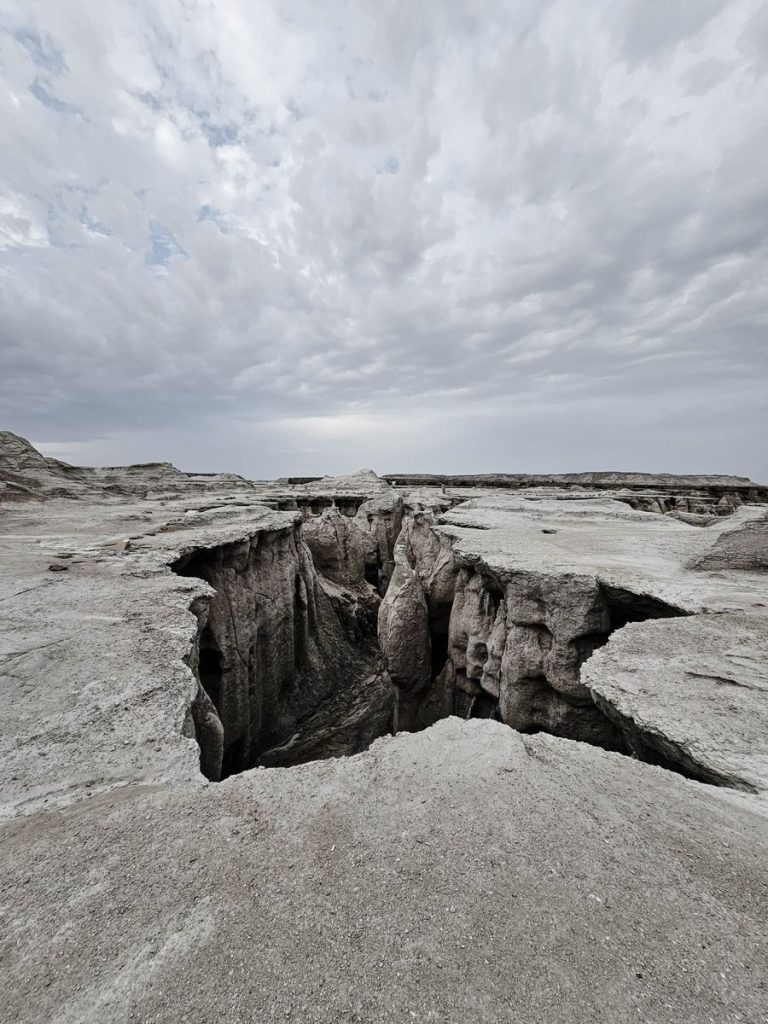 Eroded landscape of Qeshm Island canyon with dramatic clouds in Iran.