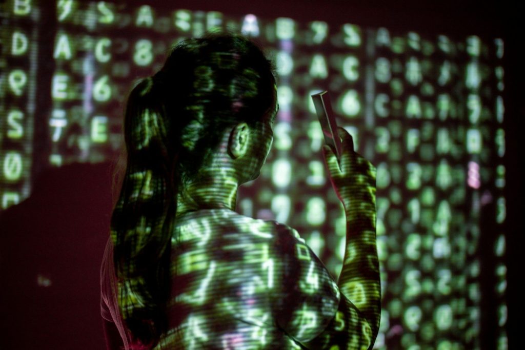 a person with long hair playing a guitar