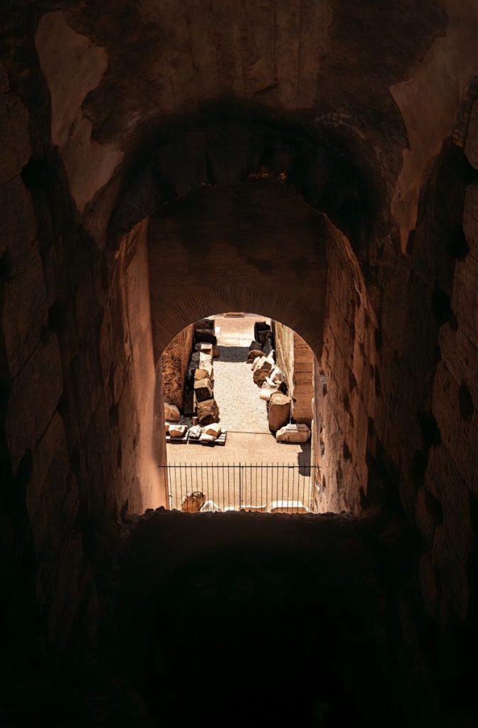 Inside an ancient stone tunnel, looking towards light.