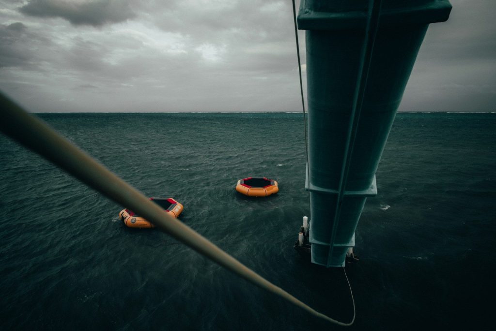 yellow and black kayak on sea under white clouds during daytime