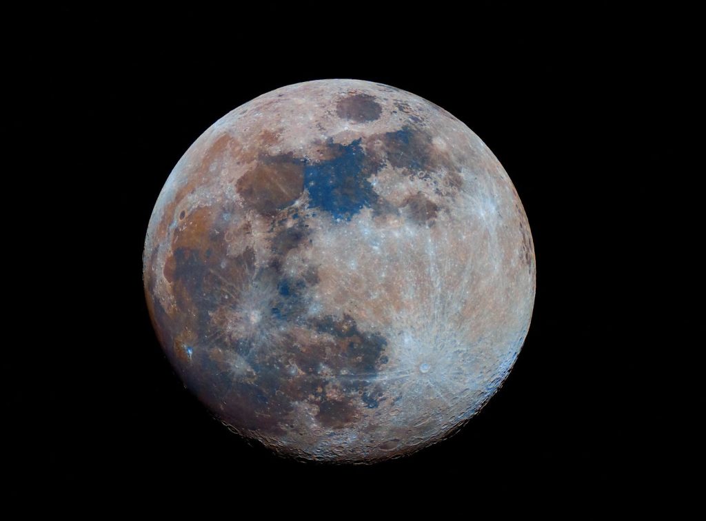 High-resolution image of the full moon showcasing vibrant color details and surface texture.
