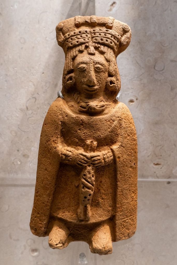 Ancient Mayan clay figurine on display showcasing cultural heritage.