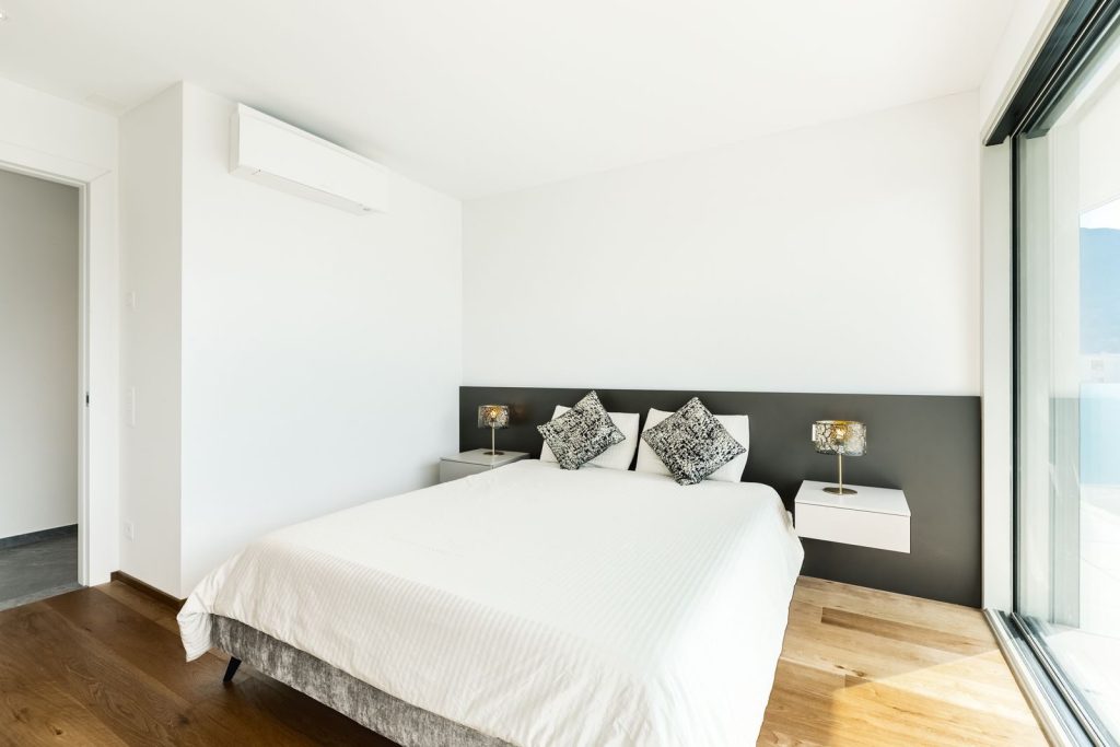 Bright, airy bedroom featuring a double bed with a minimalist and stylish design.