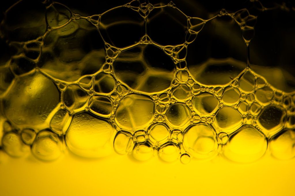 Vibrant abstract image showcasing soap bubbles in yellow light, perfect for backgrounds.
