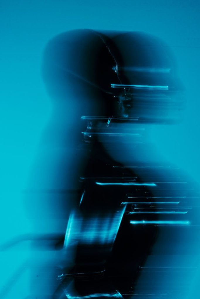 A dynamic abstract silhouette with a futuristic feel in cool blue lighting.
