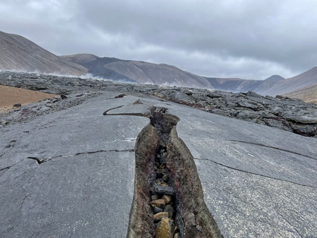 A cracked volcanic landscape near Reykjavík, Iceland showcasing rugged terrain and dramatic geology.