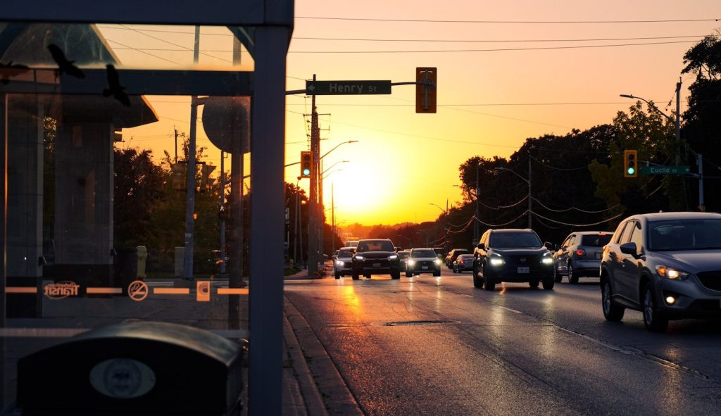 A city street filled with lots of traffic at sunset