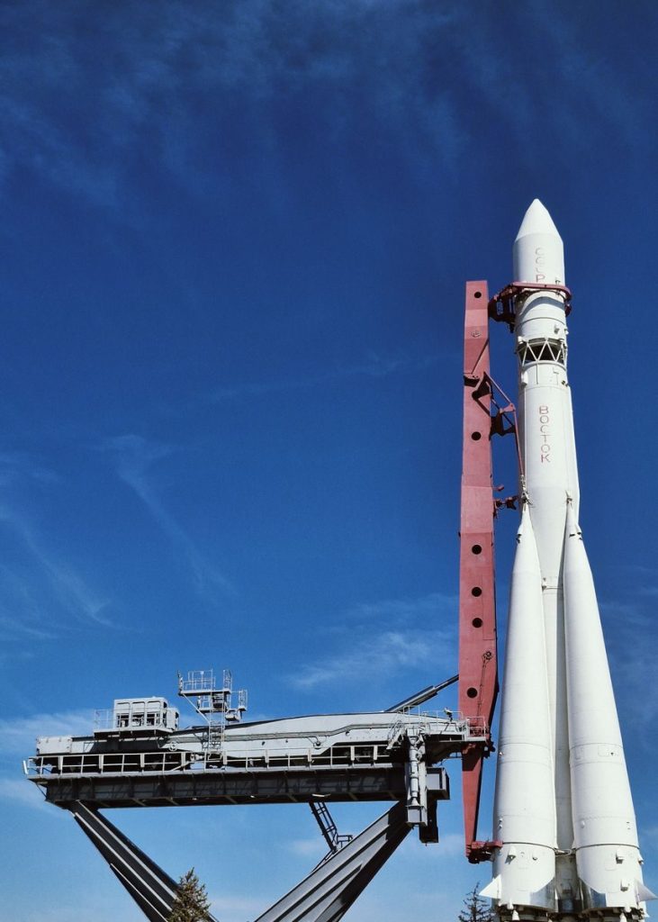 A rocket ready for launch under a vibrant blue sky, showcasing aerospace engineering.