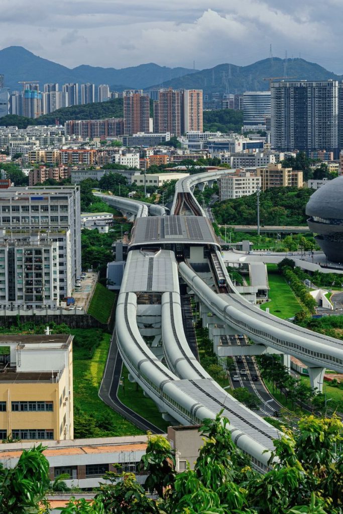 Aerial view of modern urban landscape with elevated highways and high-rise buildings.