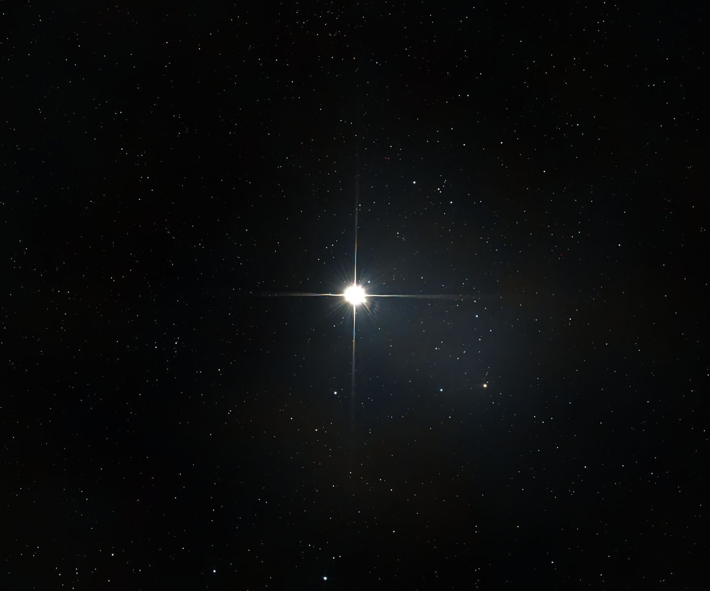 A bright star shines among countless stars in the vast, dark night sky.
