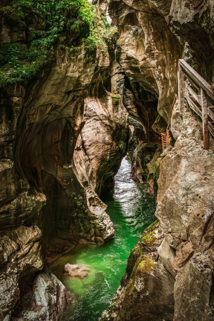 Dramatic view of a gorge with emerald waters surrounded by rocky cliffs in Scheffau am Tennengebirge, Austria.