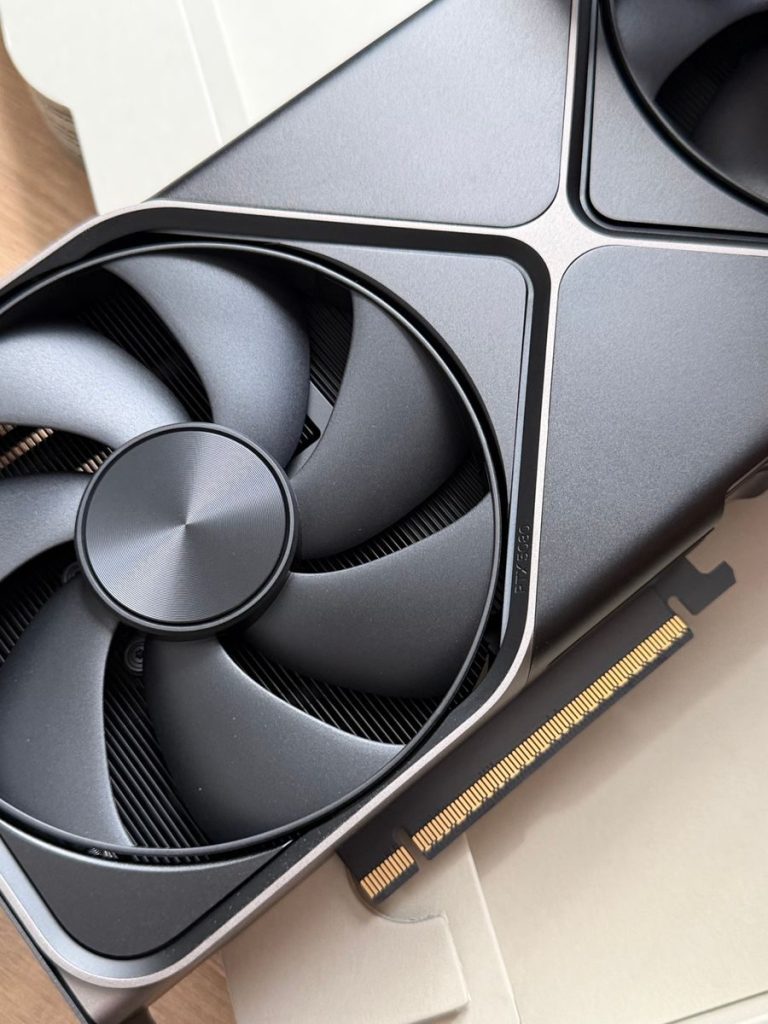 Close-up of a high-performance graphics card with detailed cooling fan design, ideal for tech enthusiasts.