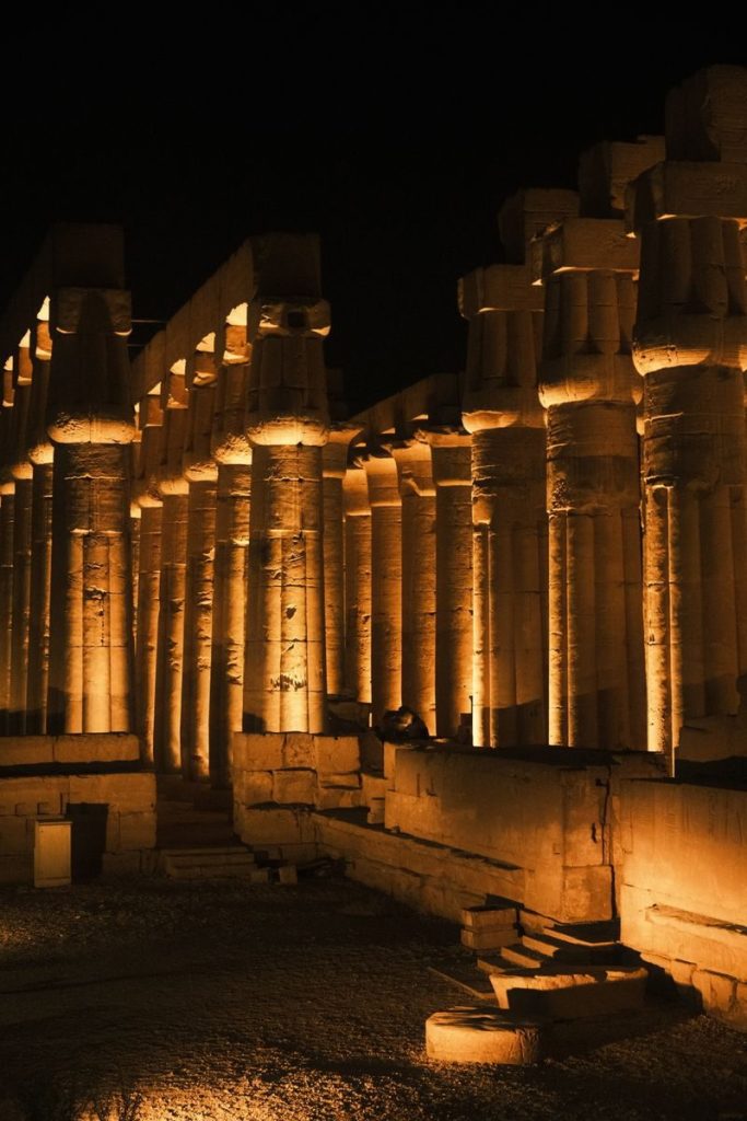 Majestic view of illuminated columns at Luxor Temple during nighttime in Luxor, Egypt.