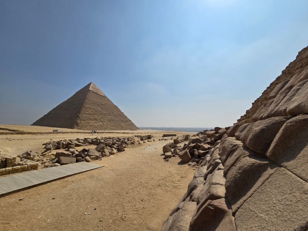 View of the Great Pyramid of Giza on a sunny day, showcasing ancient Egyptian architecture.