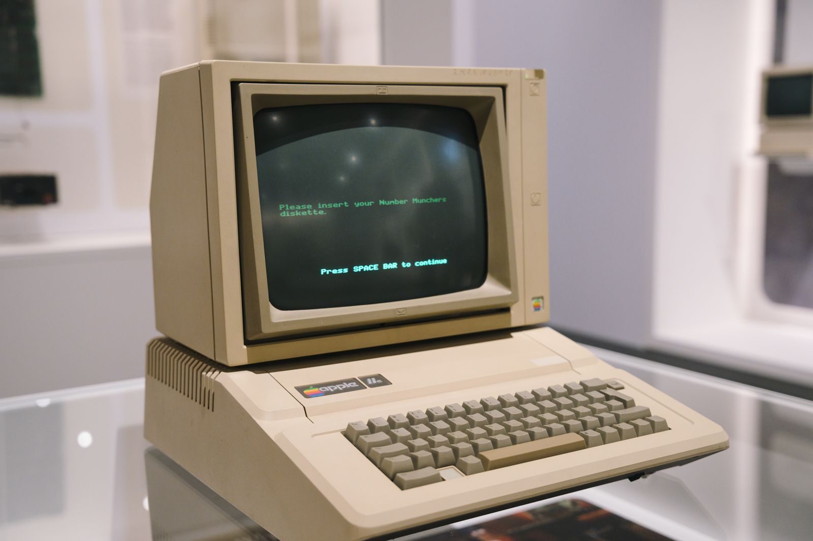 Retro Apple II computer in a museum setting, showcasing vintage technology design.