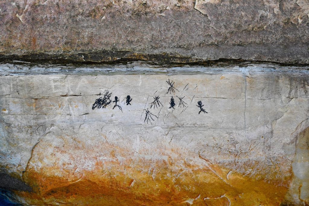 Prehistoric rock art showing stick figures and symbols found in Muraste, Estonia.