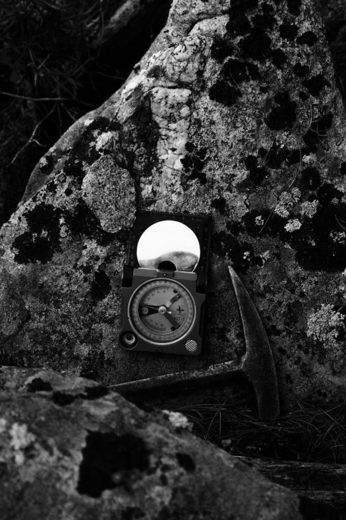 Monochrome image of geological tools on a rocky surface, ideal for geology themes.