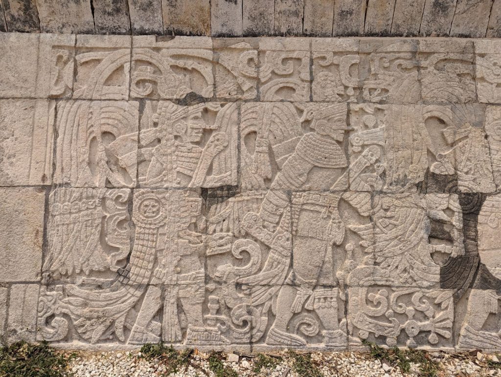 Detailed view of stone carvings at Chichen Itza, showcasing ancient Mayan art and history.