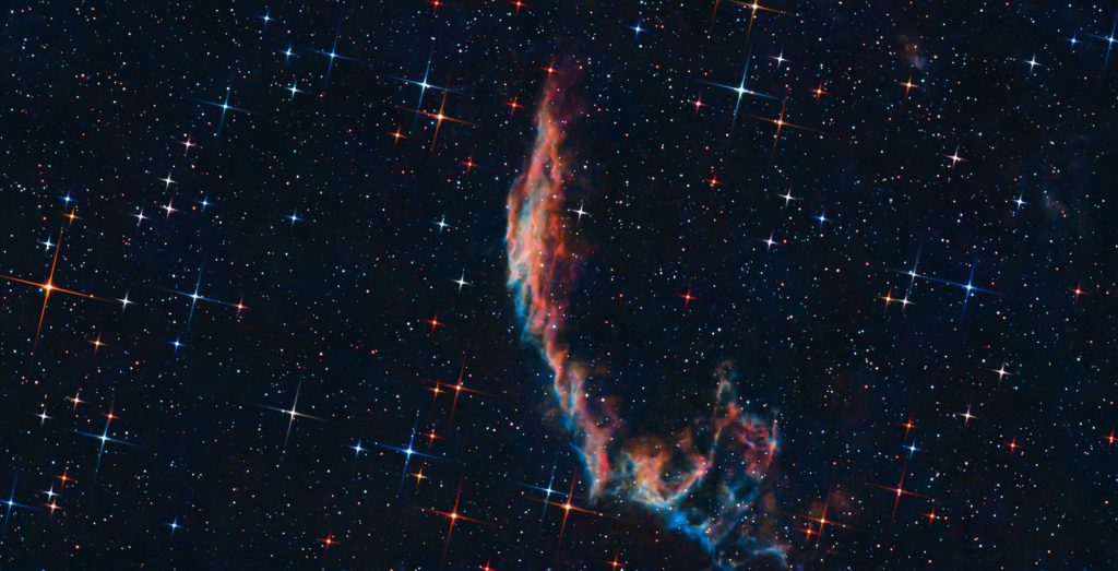 Captivating image of a vibrant nebula amidst a star-filled sky, showcasing the beauty of the universe.