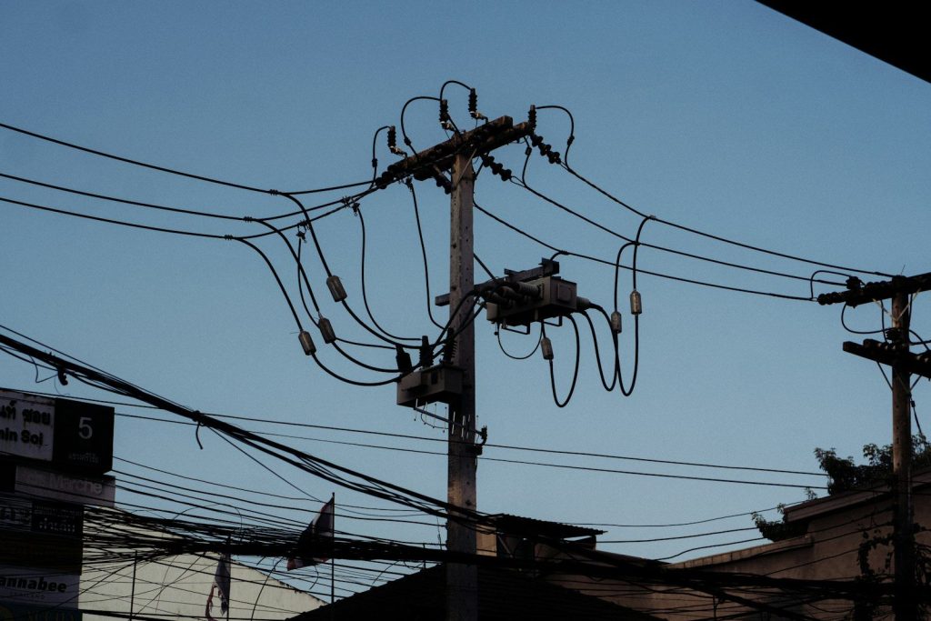 Electrical transformer on a utility pole with wires