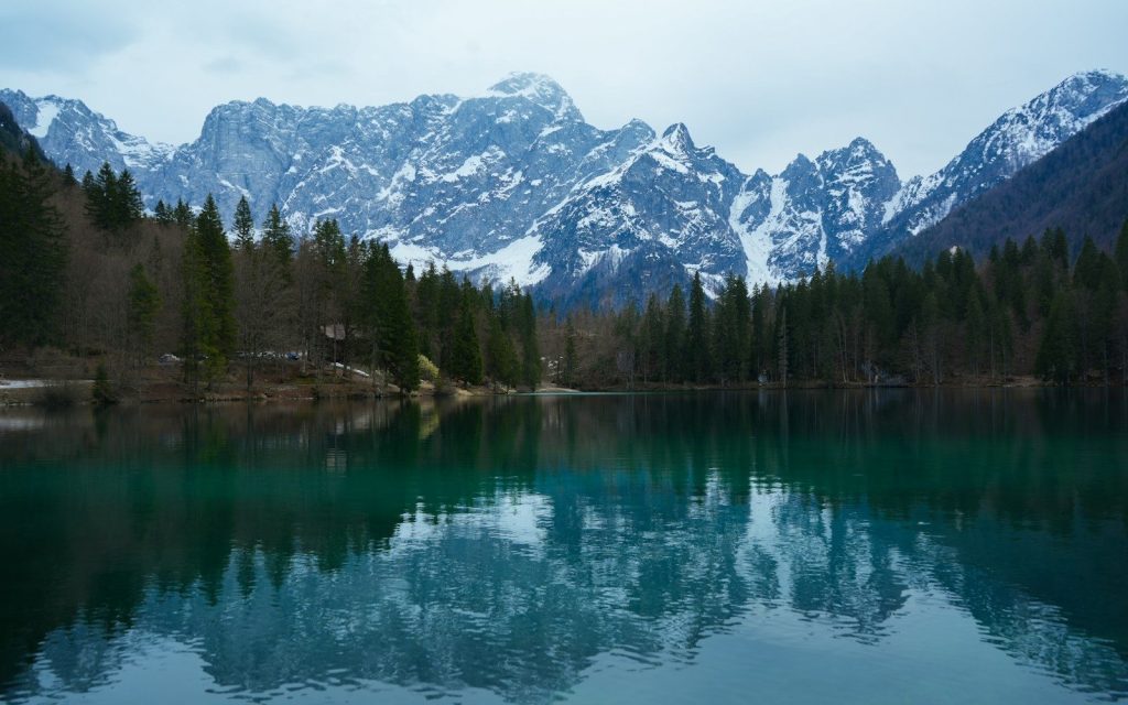 Snow-capped mountains reflected in a calm lake