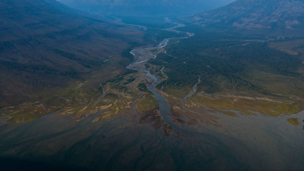 Breathtaking aerial shot over a winding river in Krasnoyarsk Krai, Russia, showcasing the region's serene natural landscape.