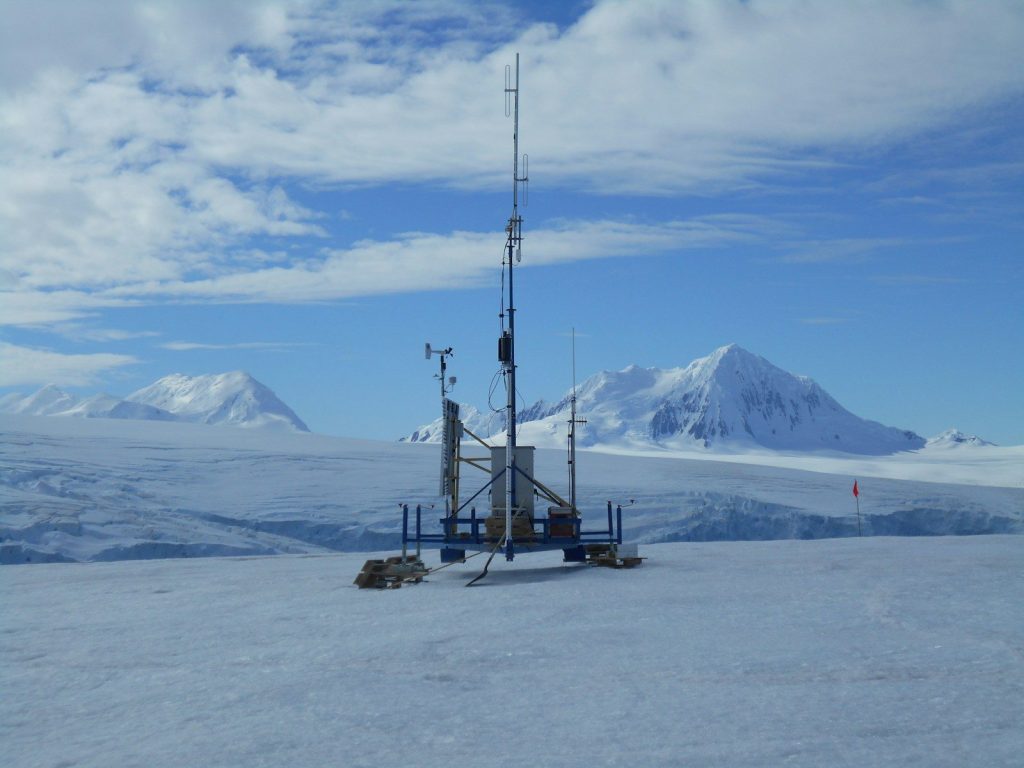 a very tall tower sitting on top of a snow covered slope