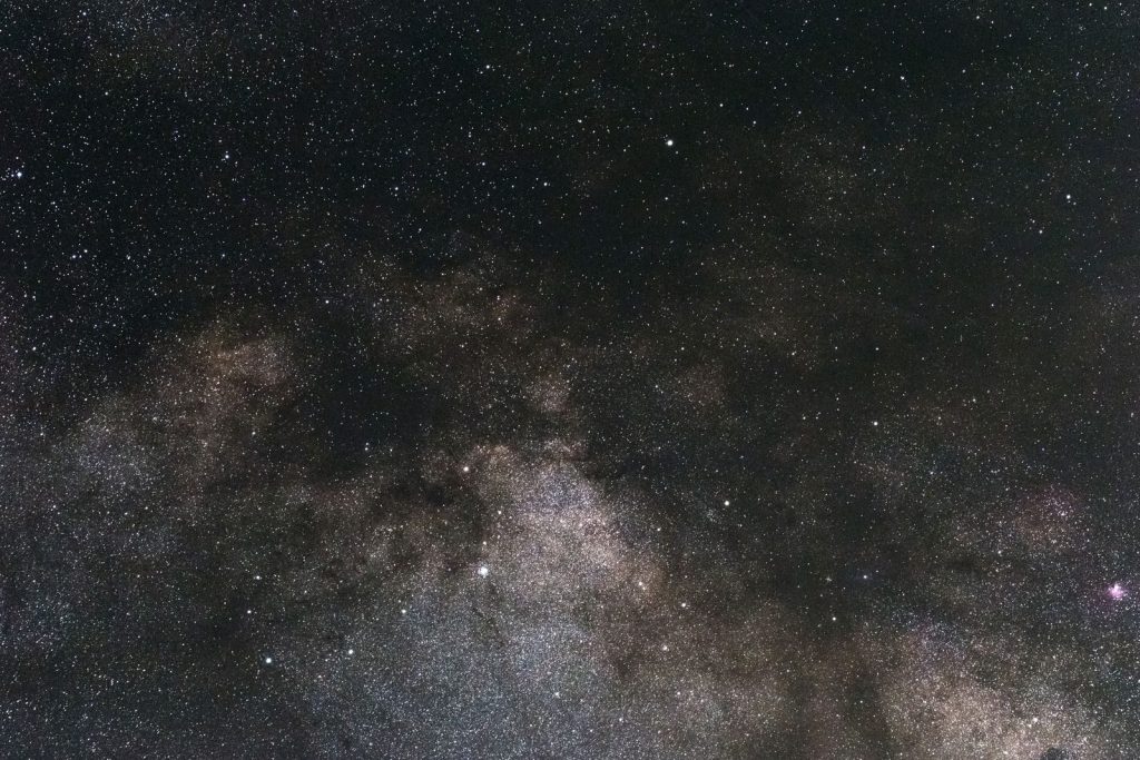 A breathtaking view high above our planet, capturing the beauty of a star-filled night sky and galaxy.