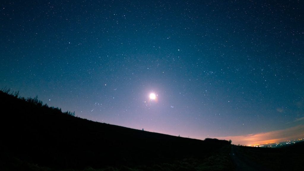 silhouette of mountain during night time