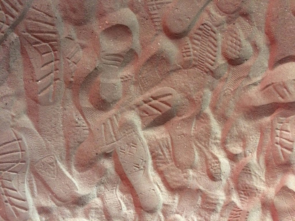 A close up of a wall with a bunch of carvings on it