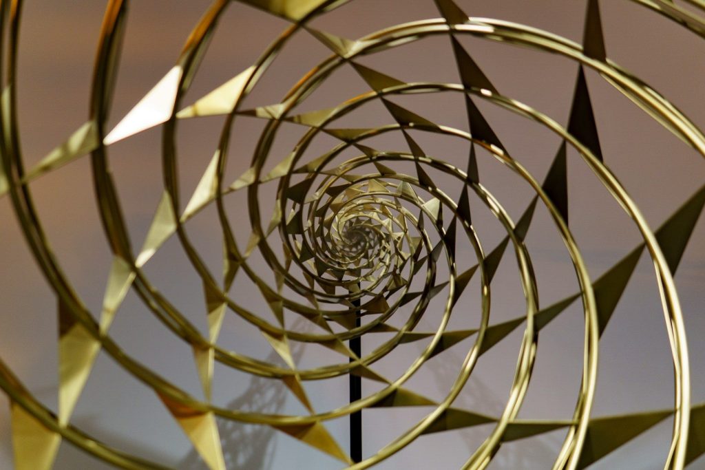 A spiral design made out of gold metal