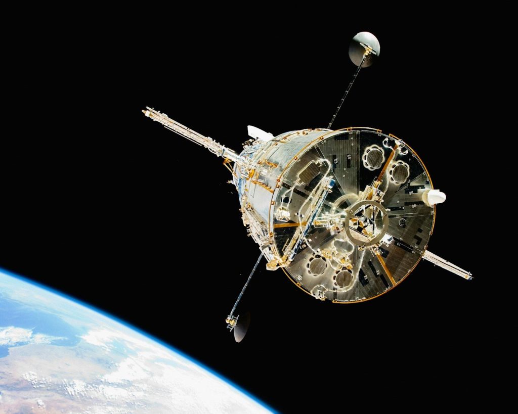 a satellite in orbit with the earth in the background