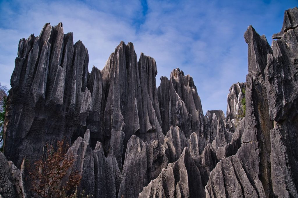 Stunning geological formations resembling stone pinnacles against a clear blue sky.