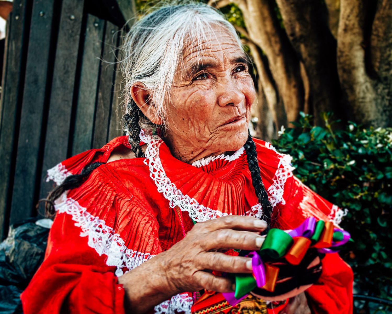 Portrait of an elderly woman in a vibrant traditional Mexican dress, captured outdoors in San Miguel de Allende.