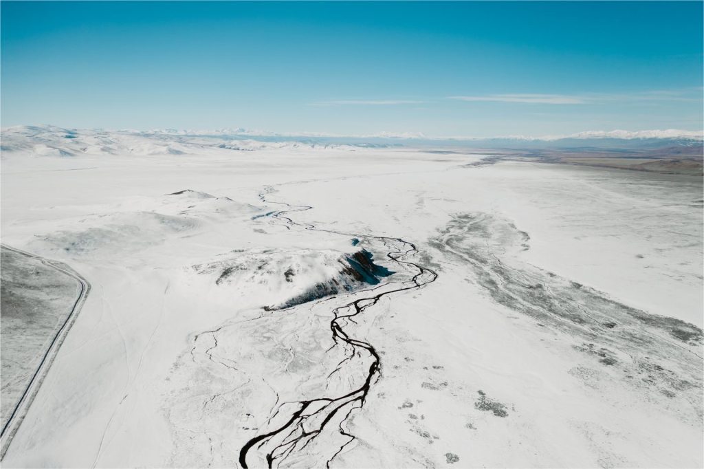 A breathtaking aerial view of a snow-covered landscape in Russia with winding rivers.
