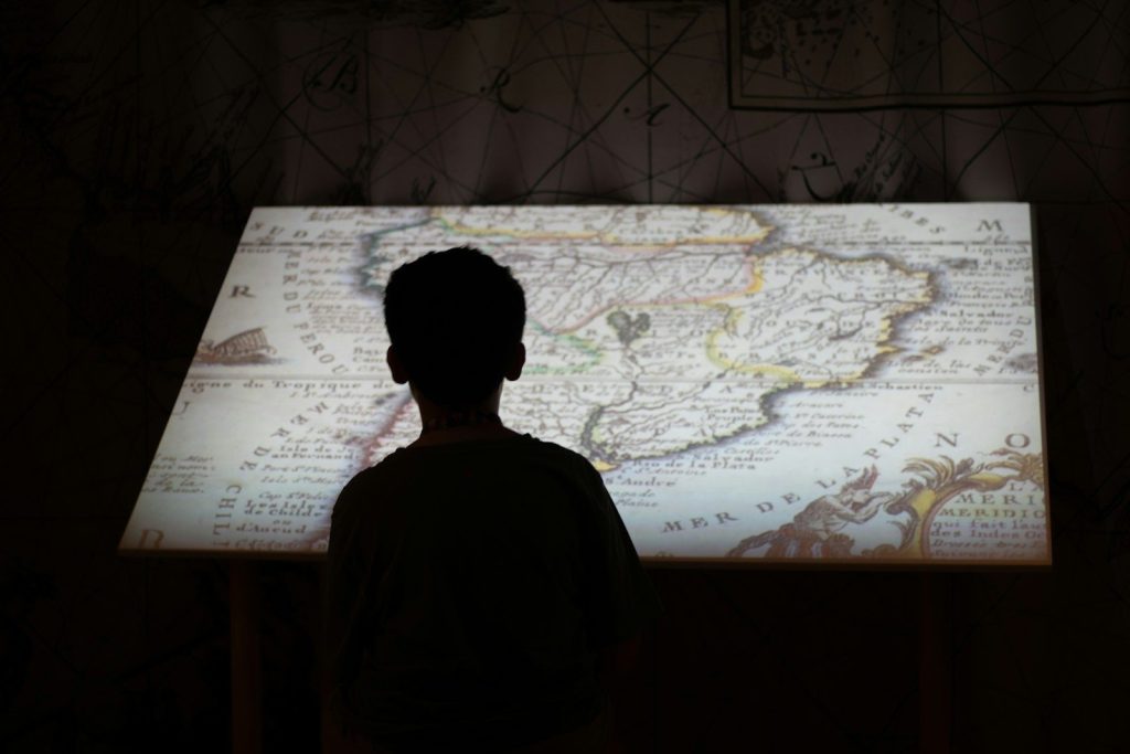 Person looking at a glowing antique map