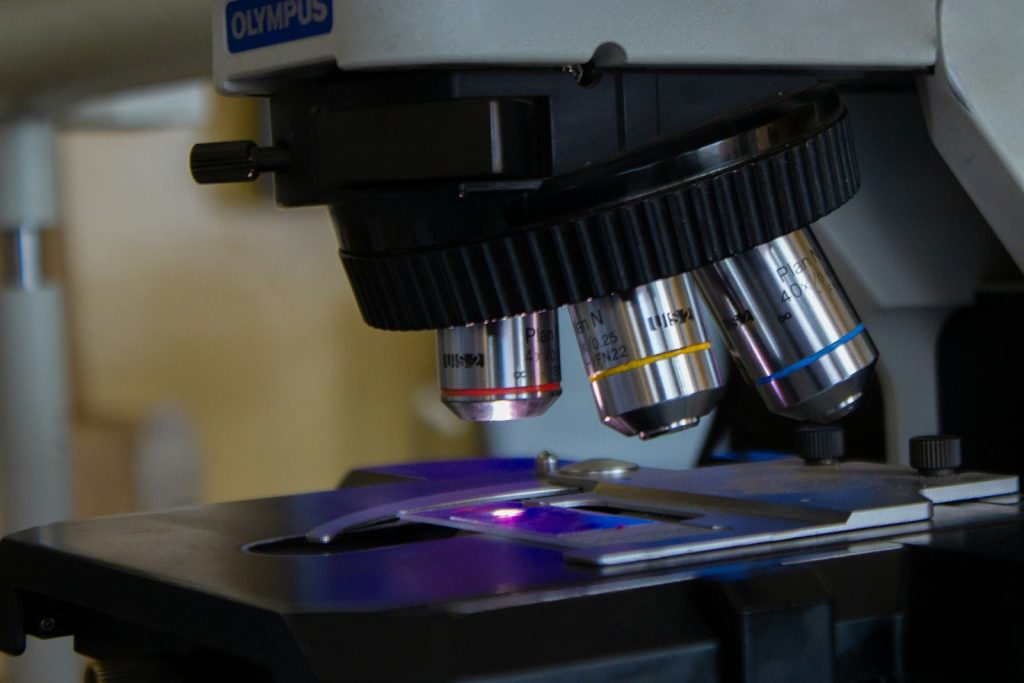 a close up of a microscope with a purple light