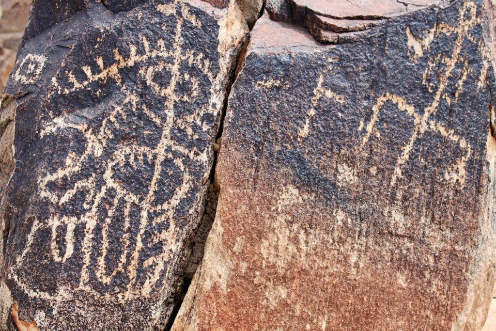 Ancient petroglyphs carved into a rock surface.