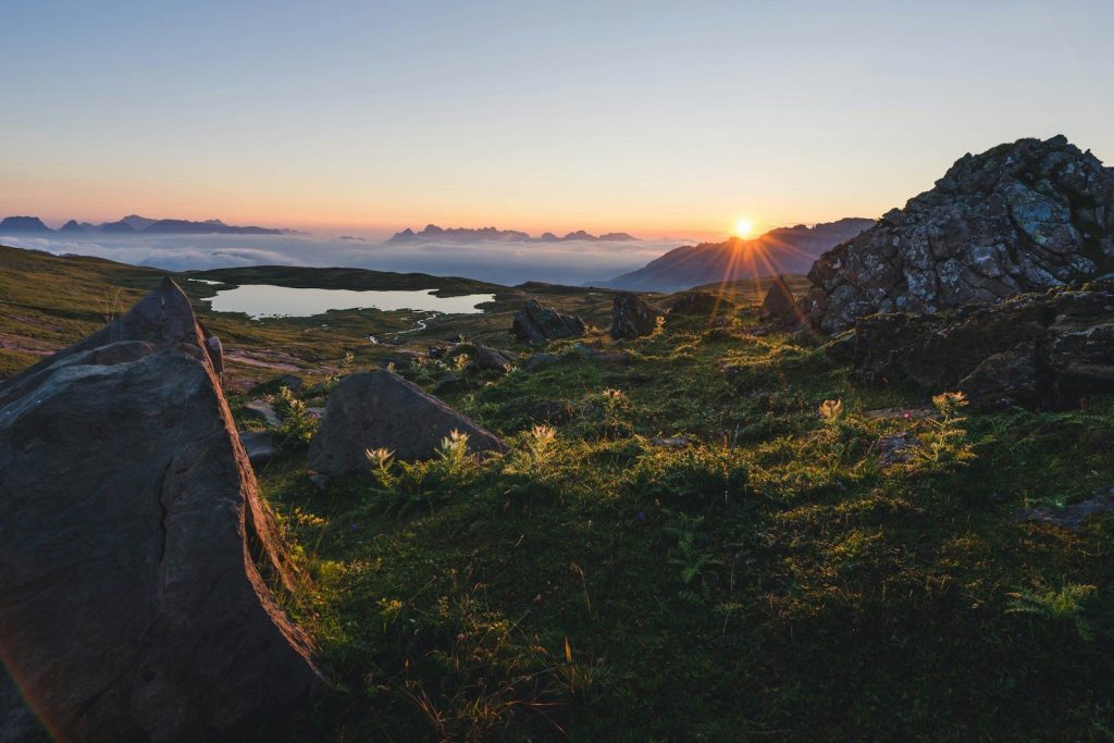 Sunset over mountains and a still lake.