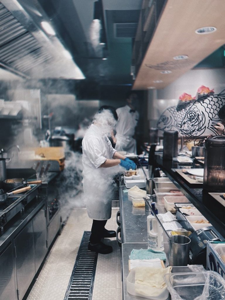man in white chef suit cooking