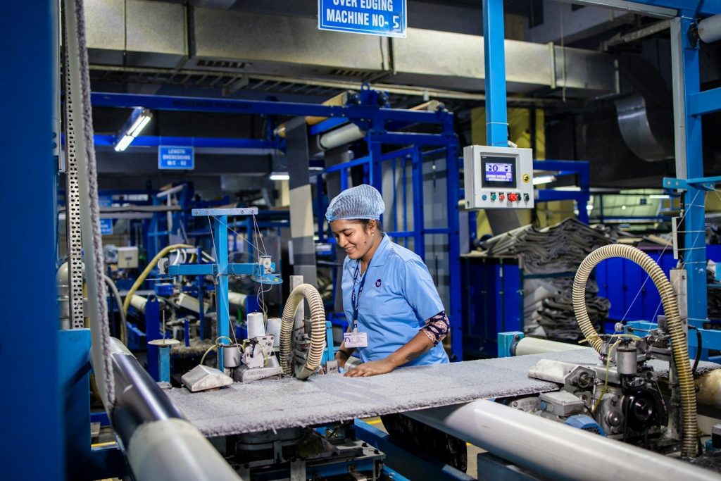 A woman is working at a factory.